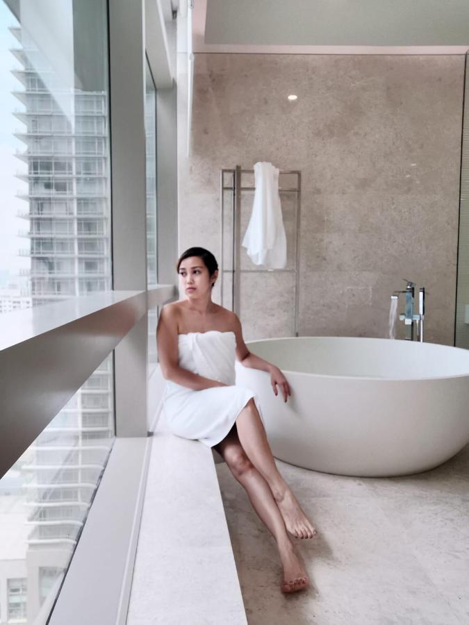 Ph Suites At Pavilion Bukit Bintang Kuala Lumpur Exterior photo A woman wrapped in a bath sheet